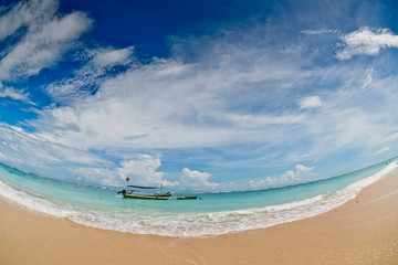Fototapeta premium A fishing boat anchored in a deserted lagoon in Bali, Indonesia.