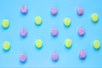 Multicolored candys on a colored background