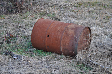 Rusted drum on the ground 