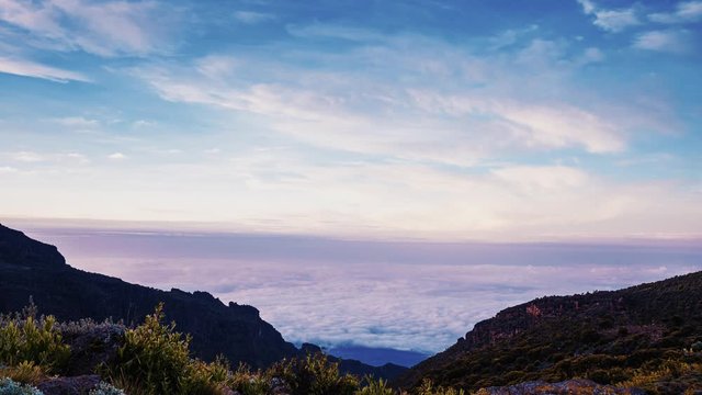 Timelapse view of Kibo with Uhuru Peak (5895m, highest mountain in Africa) at Mount Kilimanjaro, Kilimanjaro National Park. Beautiful landscape with clouds floating over the  volcano.