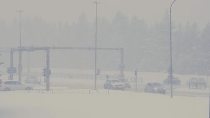 Heavy snow, traffic on the biggest intersection in Iceland during a blizzard. Reykjavik / Iceland - April 5, 2020: 