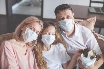 Happy family at home in mask during the pandemic coronavirus