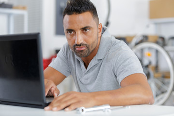 man sitting at modern office using laptop