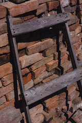 old wooden staircase on the background of a brick wall, brickwork, orange stones