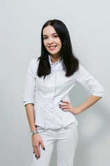 Smiling medical doctor woman isolated over white background.