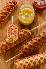 Tasty corn dogs and a jar of mustard