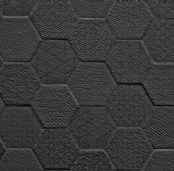Black ceramic tile with geometric rhombus pattern for wall and floor decoration. Concrete stone surface background. Solid texture for interior design project.