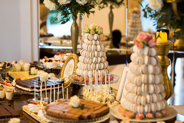 Delicious candy bar with macaroons, cupcakes and other sweets