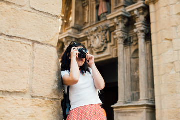 Young tourist woman making pictures of ancient monuments
