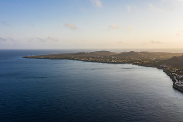 Aerial view of coast of Curacao in the Caribbean Sea with turquoise water, cliff, beach and beautiful coral reef