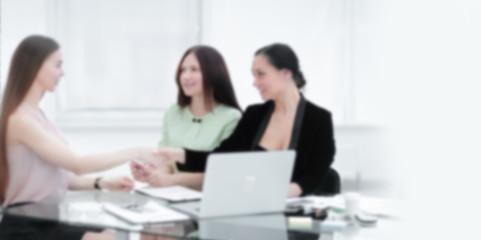 Fototapeta na wymiar handshake of business partners at your Desk.woman and business. Background for text with people in blur
