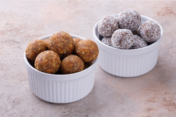 Two bowls of homemade raw chocolate and lemon energy balls. Healthy vegan and vegetarian food