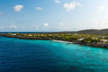 Aerial view of coast of Curacao in the Caribbean Sea with turquoise water, cliff, beach and beautiful coral reef