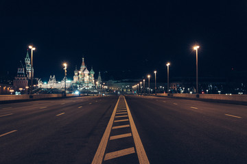 Moscow, Russia - Red square view of St. Basil's Cathedral in the night, the Red square and the bridge are empty due to a quarantine.