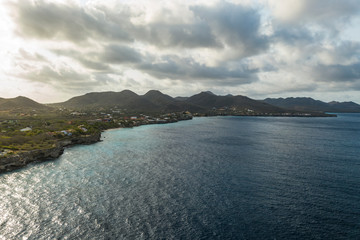 Aerial view of coast of Curacao in the Caribbean Sea with turquoise water, cliff, beach and beautiful coral reef