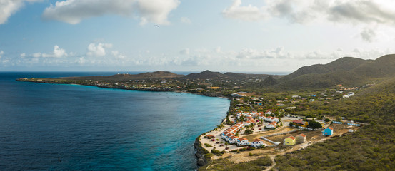 Aerial view of coast of Curacao in the Caribbean Sea with turquoise water, cliff, beach and beautiful coral reef