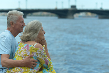 Fototapeta na wymiar Amusing elderly couple having rest near river