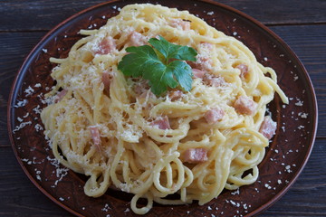Spaghetti alla Carbonara, traditional italian pasta with egg, guanciale, parmesan and pecorino cheese.