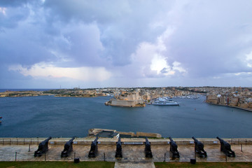 Fototapeta na wymiar The 16th century Saluting Battery at the lower tier of St. Peter & Paul Bastion overlooking Fort St. Angelo and the Grand Harbour in Valletta, Malta