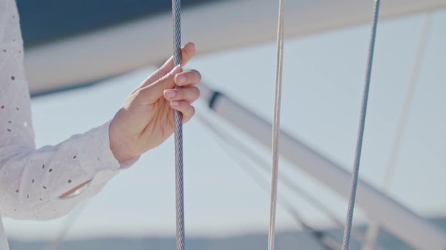 Girl holding a rope on a sailboat