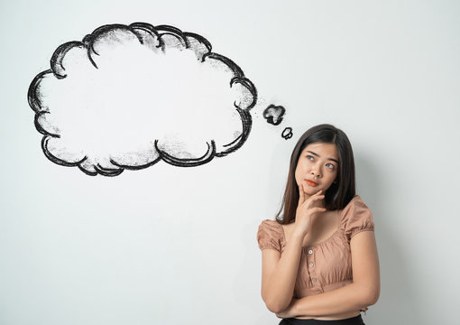 portrait of asian girl thinking and looking up to blank bubble speech. ready for your design
