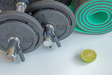 a set of dumbbells and a mat for sports
