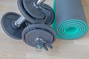 a set of dumbbells and a mat for sports