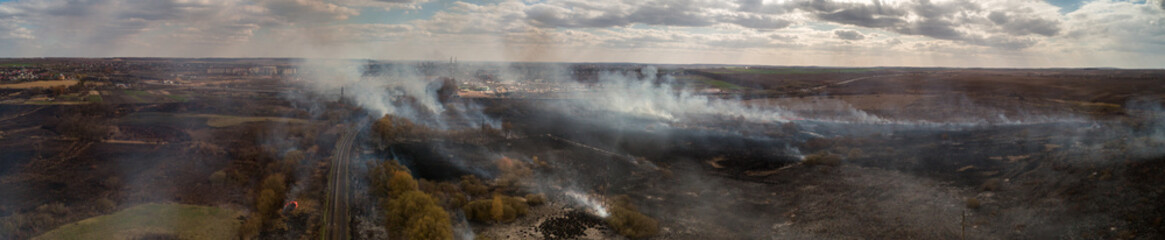 Large-scale fire in the field. Grass burns, lots of smoke. Ukraine. Rivne.