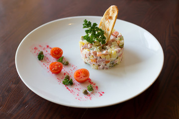 Russian-style salad on white plate