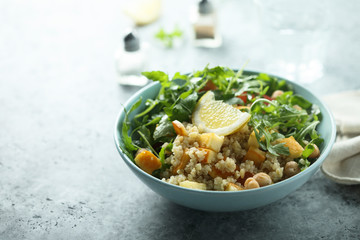 Healthy quinoa bowl with chickpea, cheese and arugula