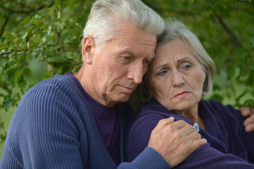 Portrait of unhappy senior couple in the park