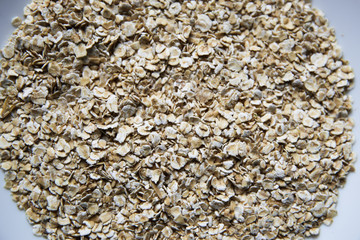 Raw oats in white plate 