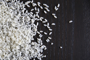 Raw white rice on wooden background