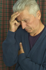 Portrait of thoughtful senior man at home