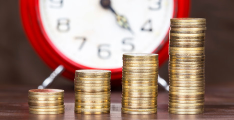 Coronavirus financial stimulus, aid package symbol, help concept. Gold money coins and alarm clock in the background, growing, web banner.