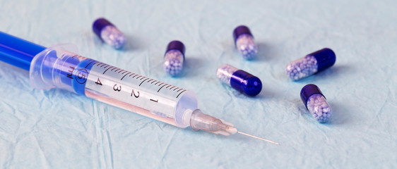Coronavirus COVID-19 immunization concept, injection and pill capsules