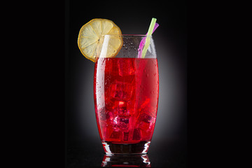 glass with red drink with ice
