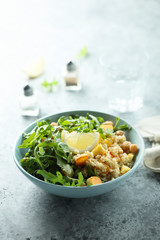 Healthy quinoa bowl with chickpea, cheese and arugula