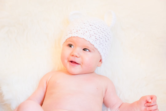 Cute Baby Girl Laughing and Wearing a Soft Knit Bear Ears Hat