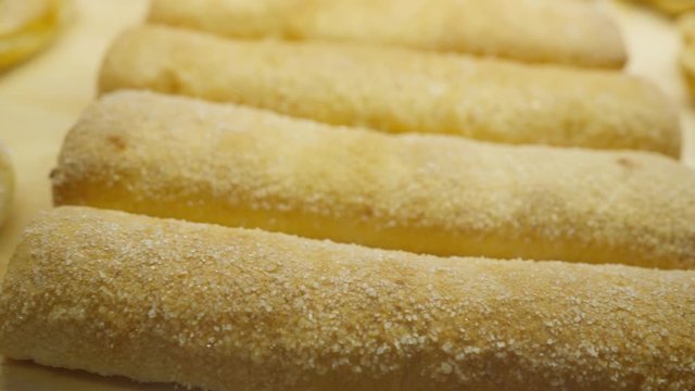 displaying of freshly made tasty pastries and crisp roasted croissants through bakery window in the coffee shop, slow motion