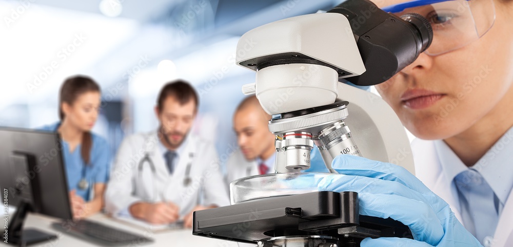 Poster the young scientist team has researching in the laboratory with a microscope.