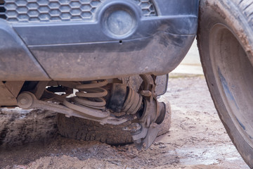 A car without a wheel. The car's wheel fell off. Wheel near the car. Damage to the front-wheel drive of the car. Car repair, breakdown on the road.