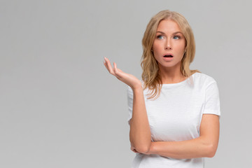 What wrong. Ambushed shocked confused young girl coworker shrugging hands spread sideways full...