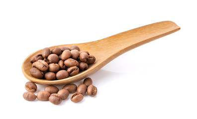 roasted coffee beans in wood spoon on a white background full depth of field