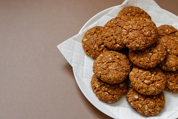 oatmeal cookies on a white plate on a brown background