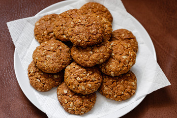 oatmeal cookies on a white plate on a brown background