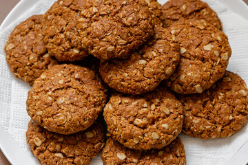 oatmeal cookies on a white plate on a brown background