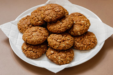 oatmeal cookies on a white plate on a brown background