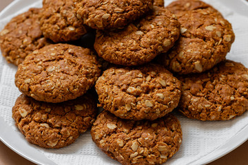oatmeal cookies on a white plate on a brown background