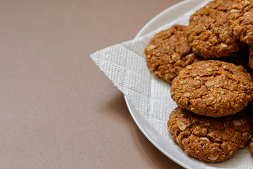 oatmeal cookies on a white plate on a brown background